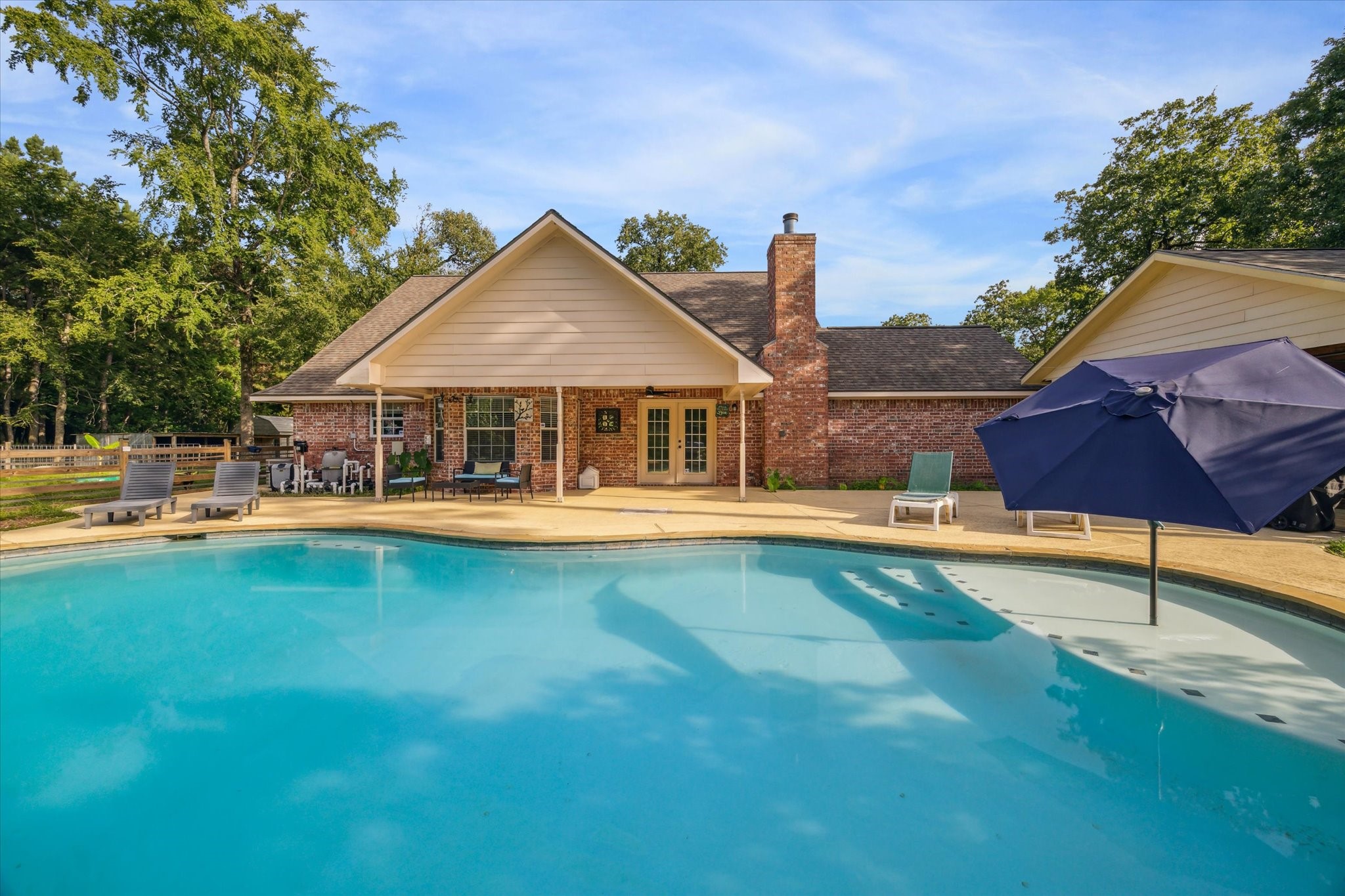 19215 Veterans Road Magnolia, TX 77355 - Photo 40 of 50 a view of a house with swimming pool and porch