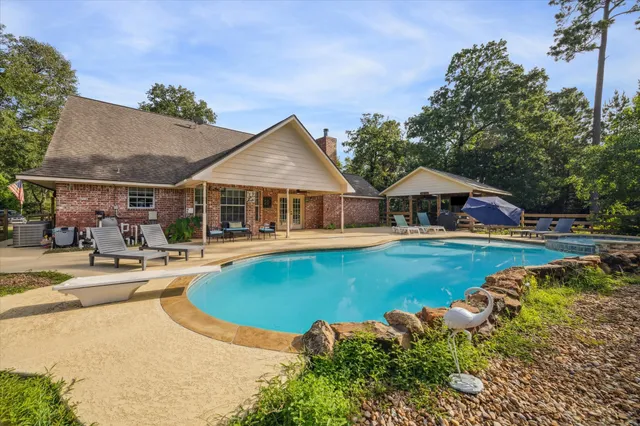 a swimming pool with outdoor seating and yard