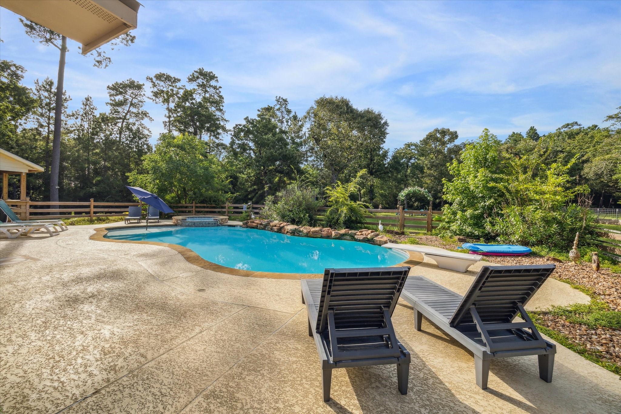 19215 Veterans Road Magnolia, TX 77355 - Photo 42 of 50 a view of a swimming pool with a lounge chair