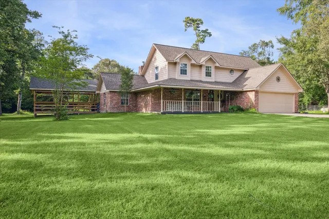 a view of a house with a yard and sitting area