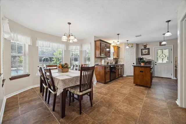 a large kitchen with a table and chairs