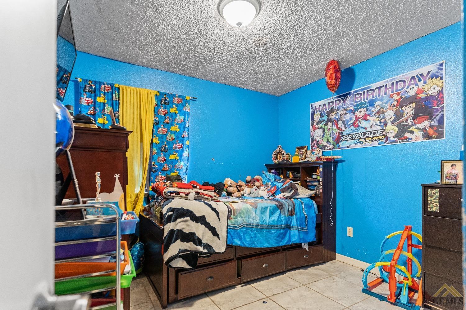 Undisclosed Address Bakersfield, CA 93304 - Photo 14 of 19 a bedroom with a bed and dresser