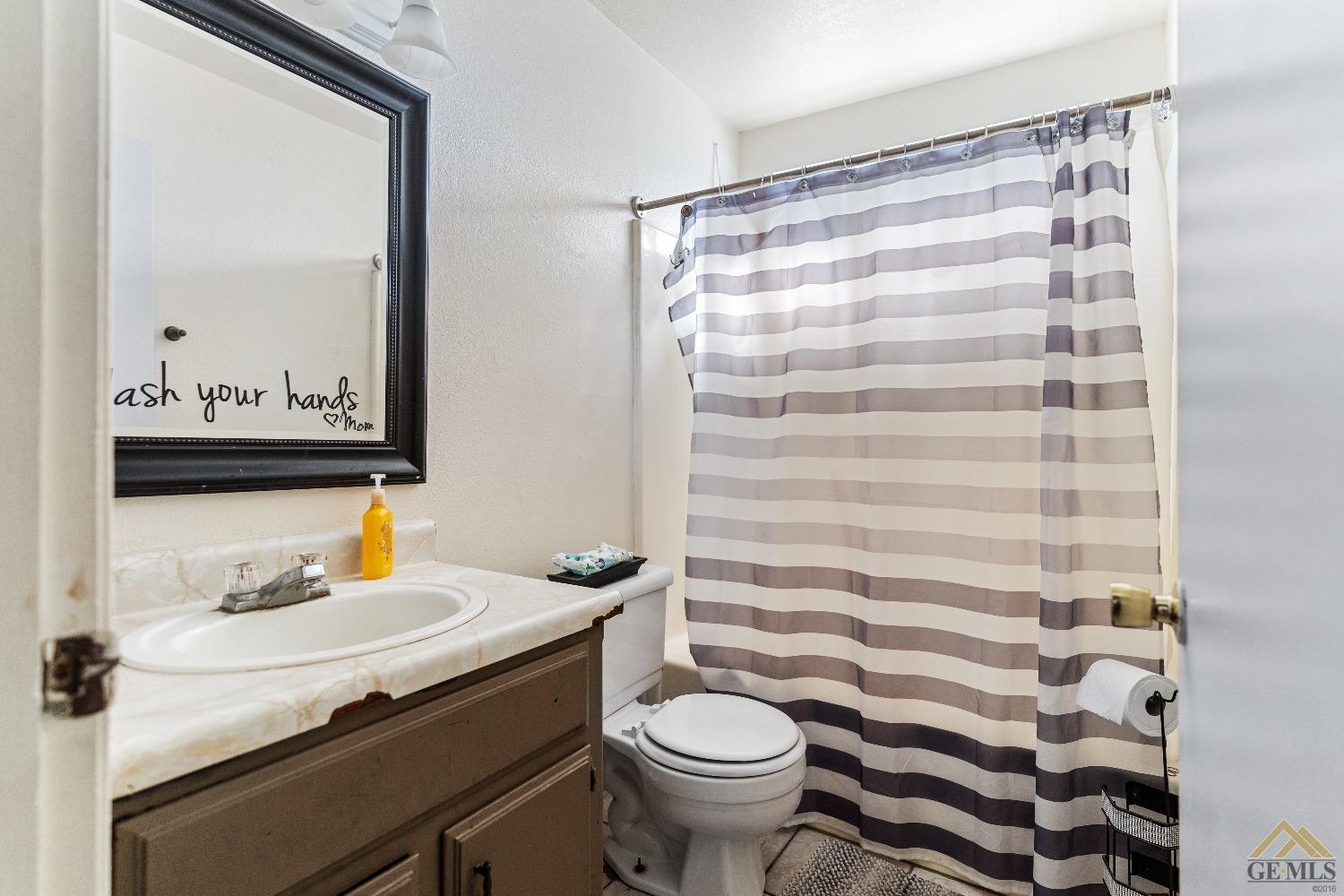 Undisclosed Address Bakersfield, CA 93304 - Photo 15 of 19 a bathroom with a sink toilet and shower