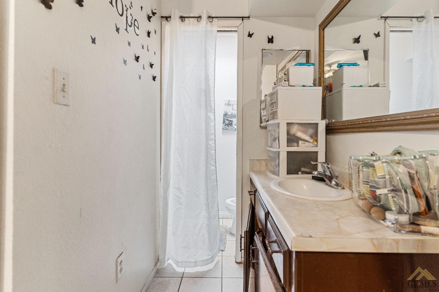 Undisclosed Address Bakersfield, CA 93304 - Photo 19 of 19 a bathroom with a sink and a mirror