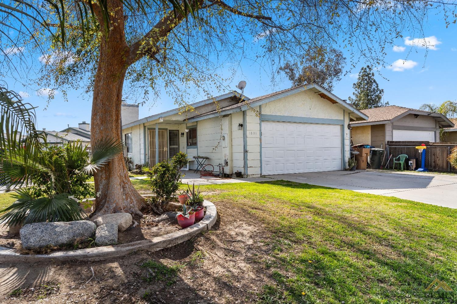 Undisclosed Address Bakersfield, CA 93304 - Photo 2 of 19 a front view of a house with garden