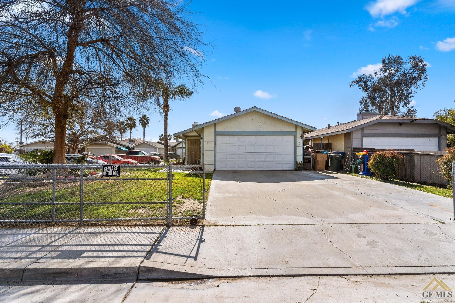 Undisclosed Address Bakersfield, CA 93304 - Photo 3 of 19 a front view of a house with a garden