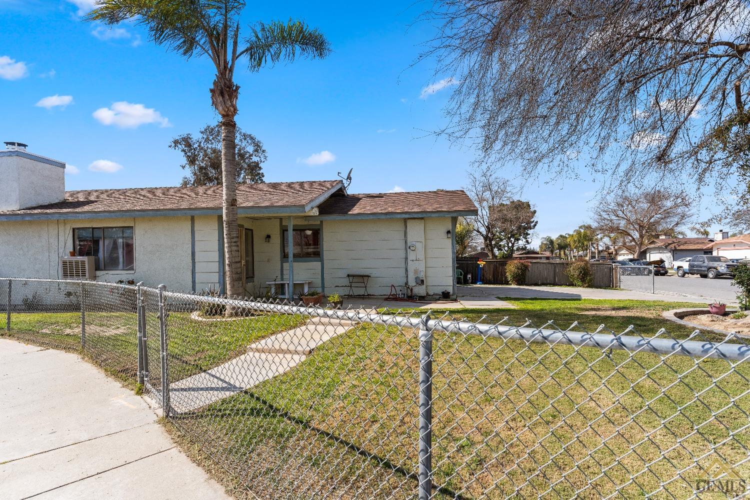 Undisclosed Address Bakersfield, CA 93304 - Photo 4 of 19 a view of a house with swimming pool and a yard