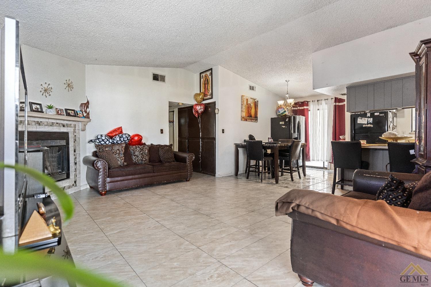 Undisclosed Address Bakersfield, CA 93304 - Photo 6 of 19 a living room with furniture and a fireplace