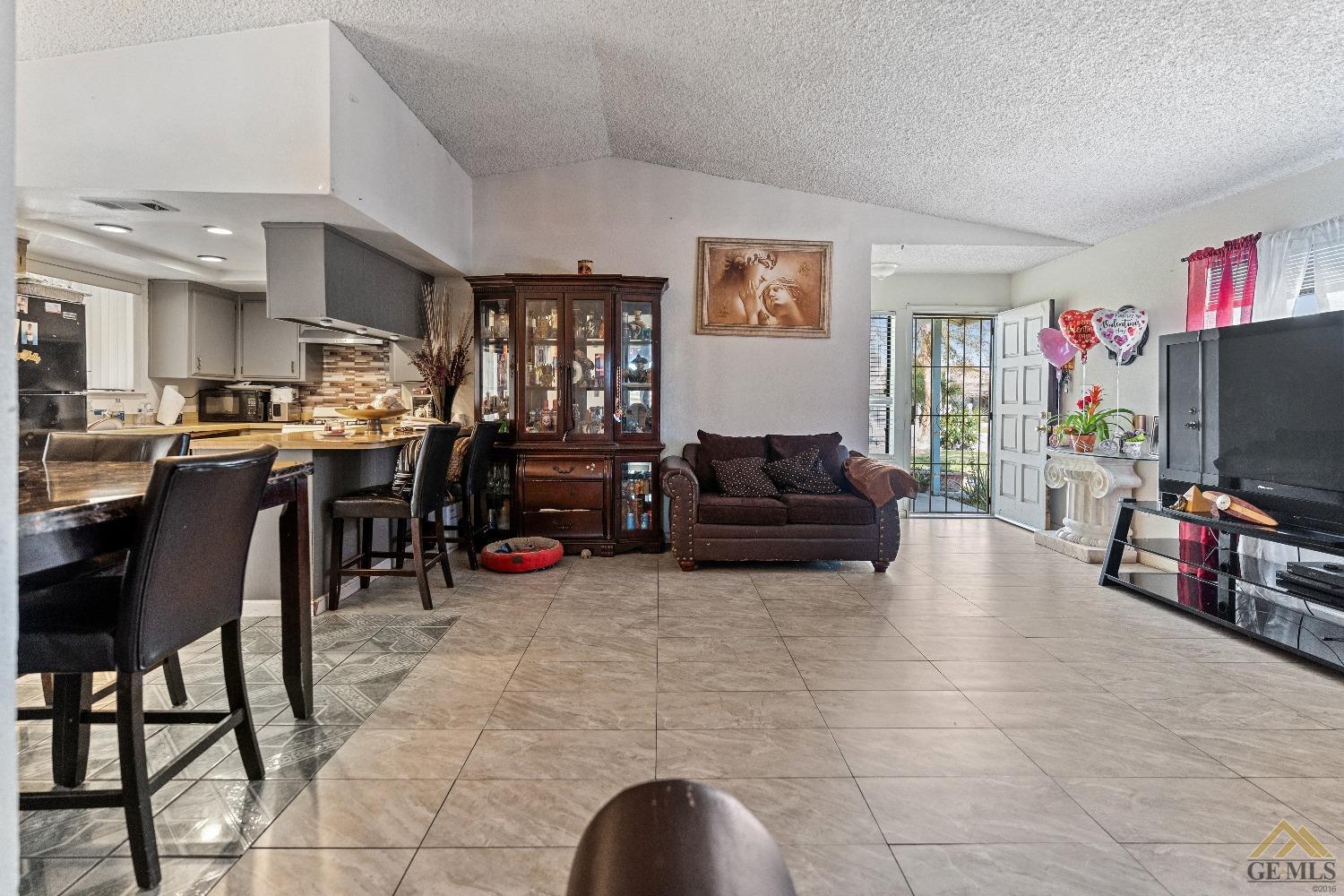 Undisclosed Address Bakersfield, CA 93304 - Photo 8 of 19 a living room with furniture and a flat screen tv