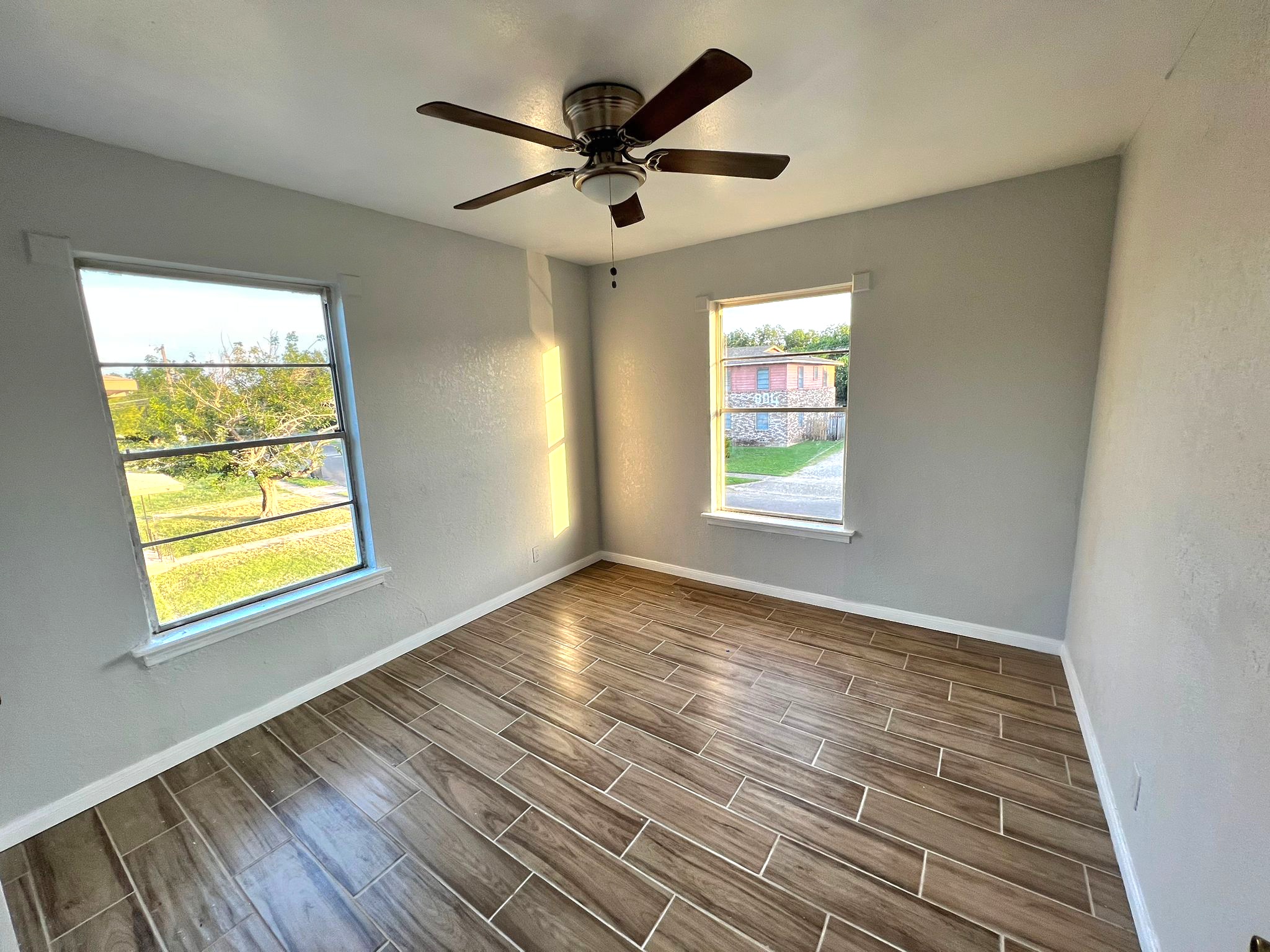 805 Sissom Road Killeen, TX 76541 - Photo 19 of 35 Empty room with wood tiled floors, a ceiling fan, and a textured wall