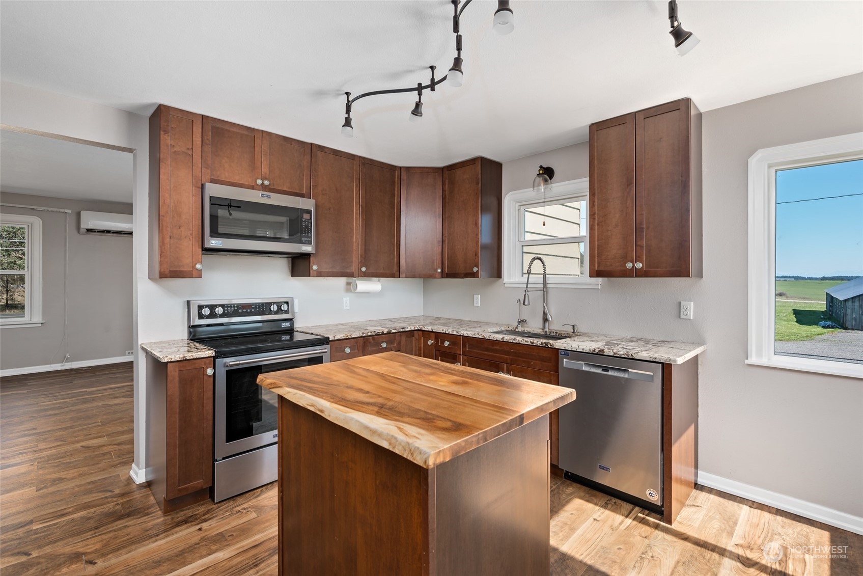 1932 Zylstra Road Oak Harbor, WA 98277 - Photo 13 of 40 a kitchen with stainless steel appliances a stove a sink a microwave and wooden cabinets