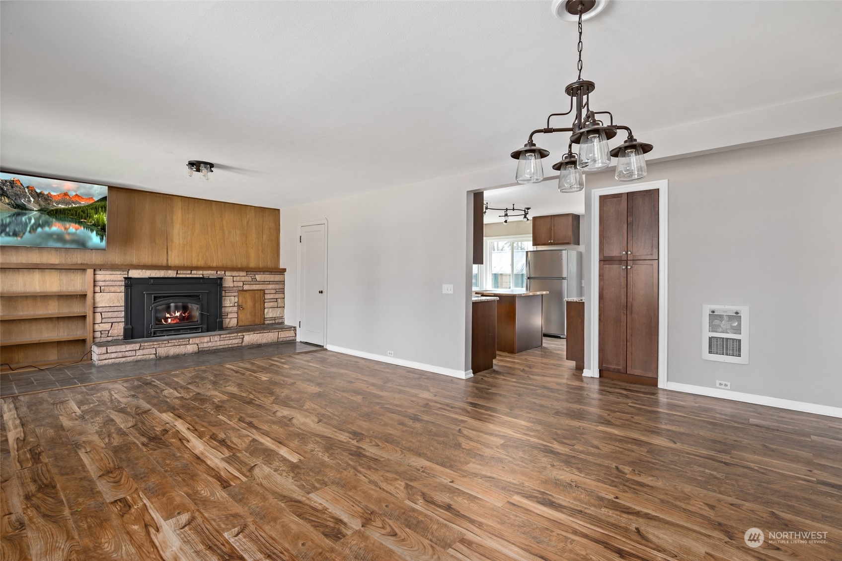 1932 Zylstra Road Oak Harbor, WA 98277 - Photo 10 of 40 a view of a livingroom with a fireplace a chandelier and wooden floor
