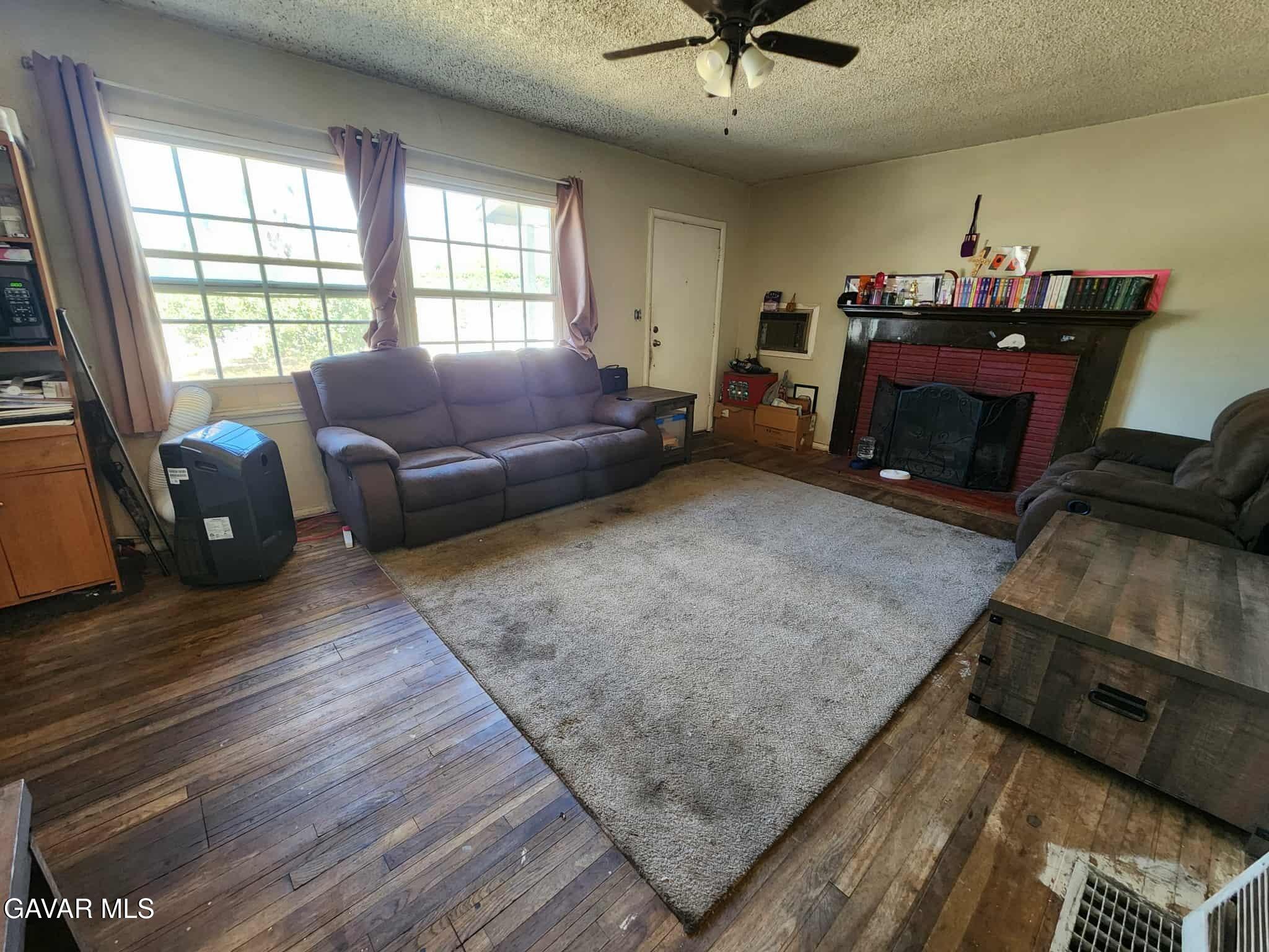 15320 Bledsoe Street Sylmar, CA 91342 - Photo 6 of 21 a living room with furniture and a fireplace