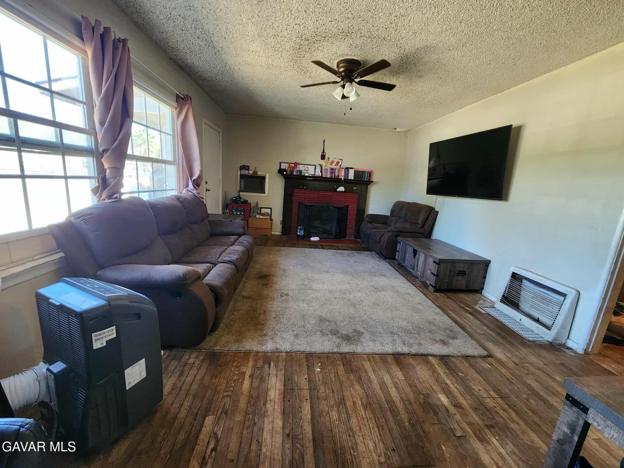 15320 Bledsoe Street Sylmar, CA 91342 - Photo 7 of 21 a living room with furniture and a flat screen tv