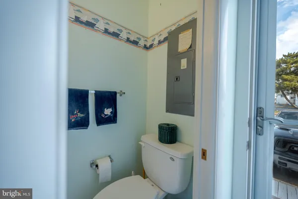 a bathroom with a toilet a sink and mirror