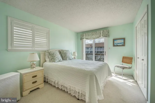 a spacious bedroom with a bed and a window