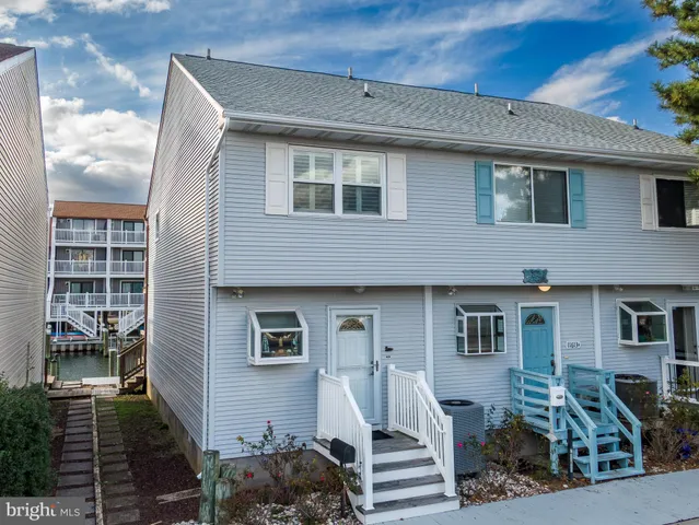 a front view of a house with many windows