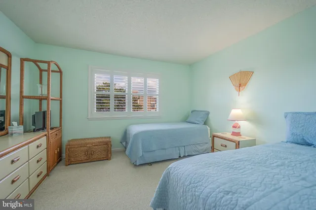 a bedroom with two beds and a window