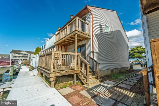 a view of a house with a wooden deck