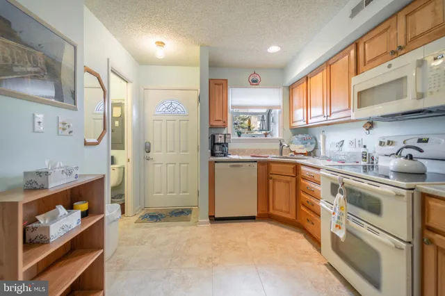 a kitchen with cabinets and window
