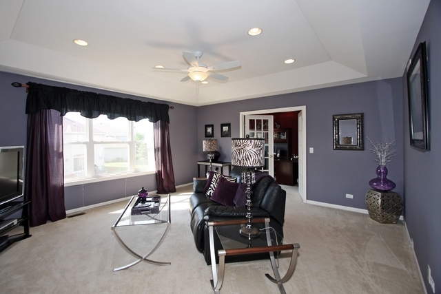 1560 Southgate Road Bartlett, IL 60103 - Photo 13 of 25 a living room with furniture and a flat screen tv