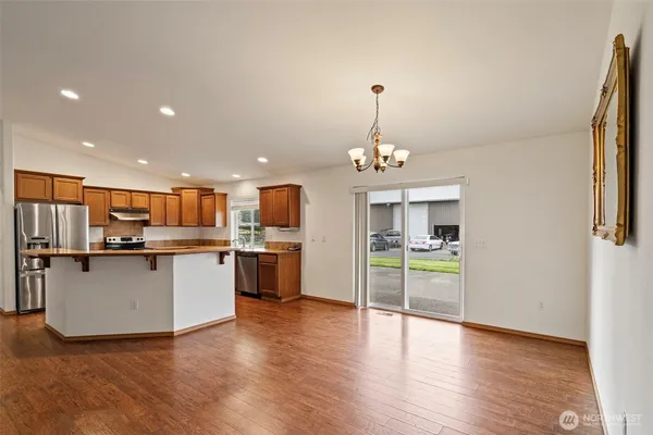 a view of a kitchen with a sink dishwasher a refrigerator and a stove top oven