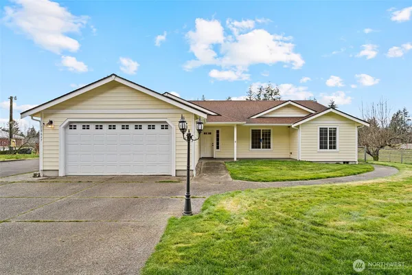 a front of a house with a yard and garage