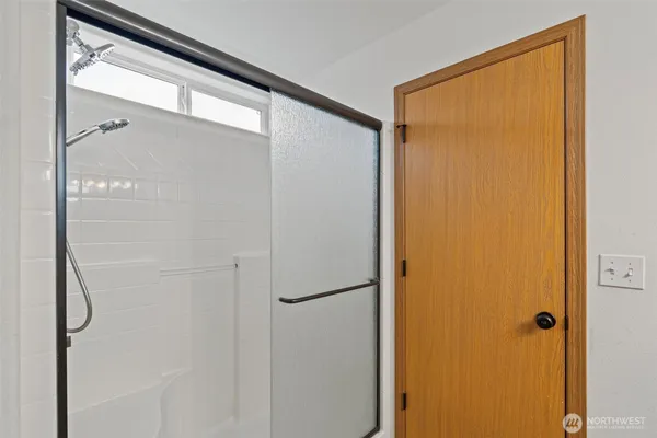 a bathroom with a glass shower door