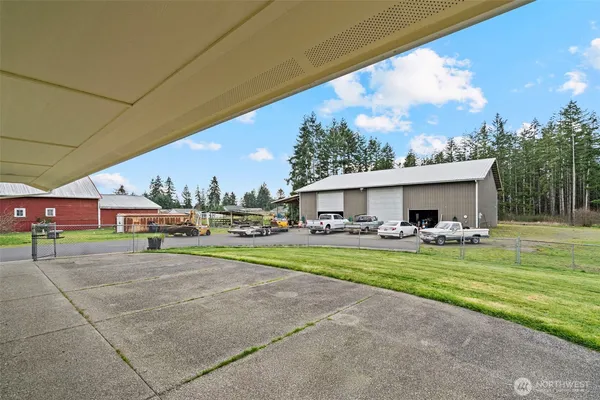 a view of a house with a yard and sitting area