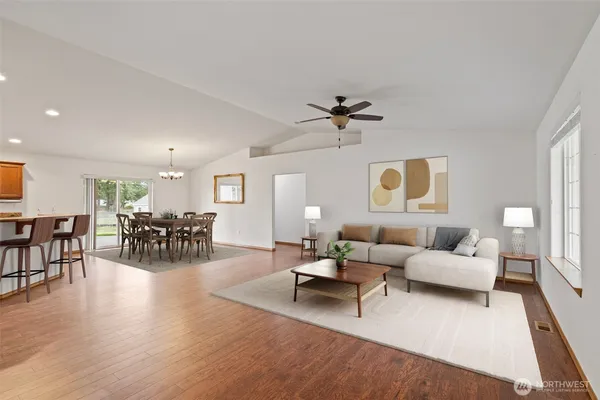 a living room with furniture and wooden floor