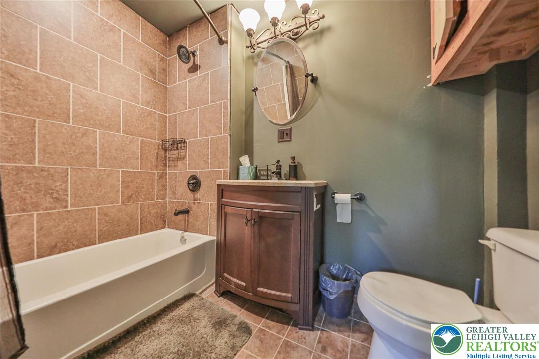 331 Cranberry Creek Road Cresco, PA 18326 - Photo 60 of 95 A compact bath featuring a tiled tub surround and a practical vanity with a sink.
