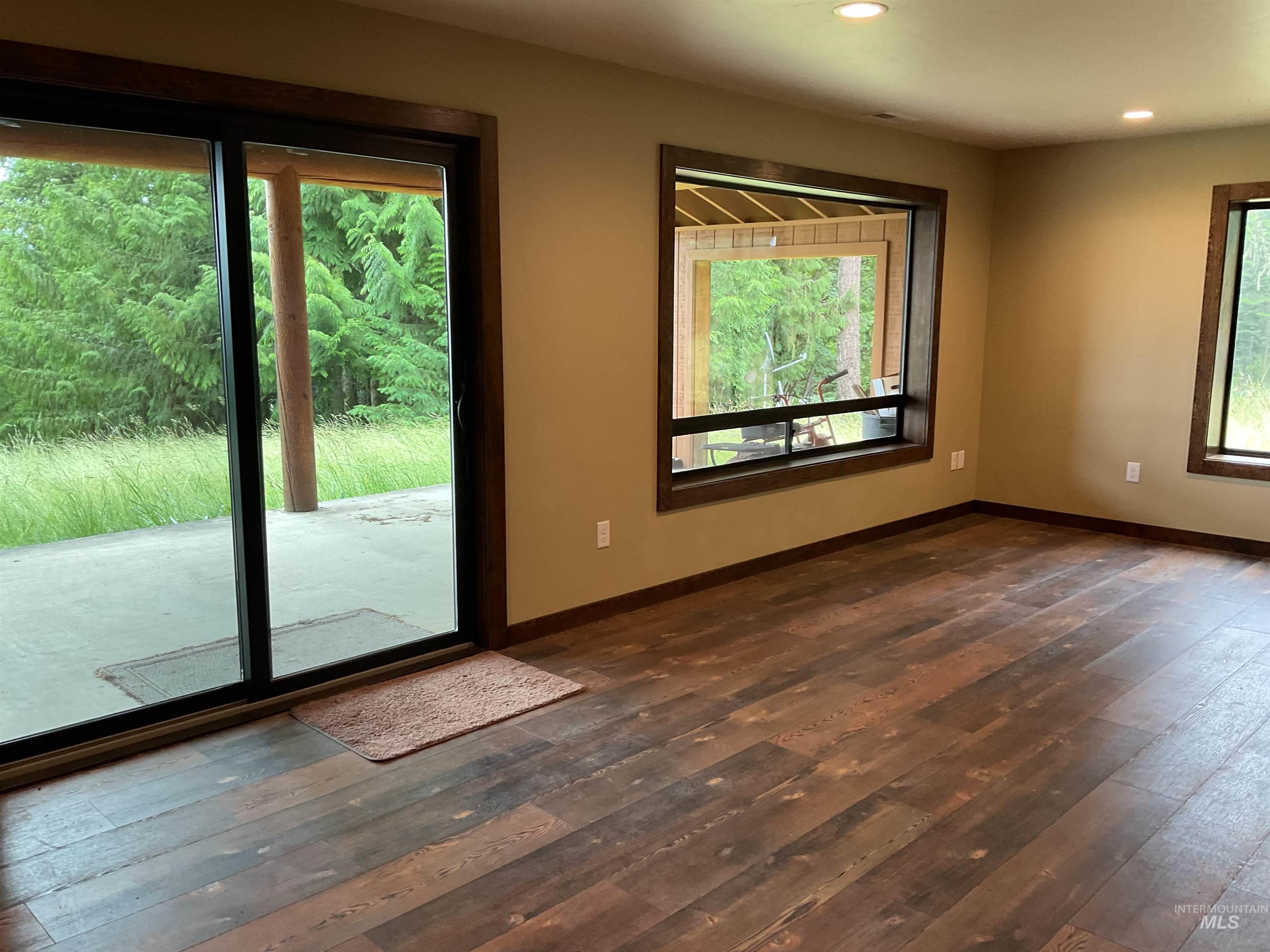 6125 Freeman Creek Road Lenore, ID 83541 - Photo 32 of 44 Spacious interior featuring wood-finish flooring, recessed lighting, and large windows with dark wood trim