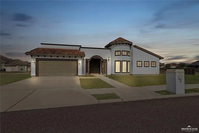 a view of a big house with a street