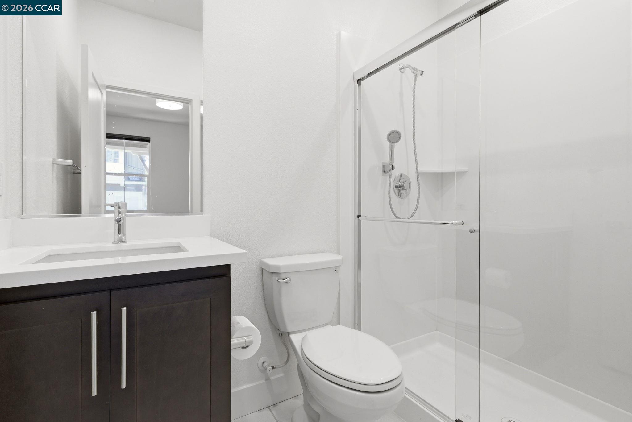 205 Plum Tree Street Livermore, CA 94551 - Photo 39 of 47 a bathroom with a toilet a sink shower and mirror