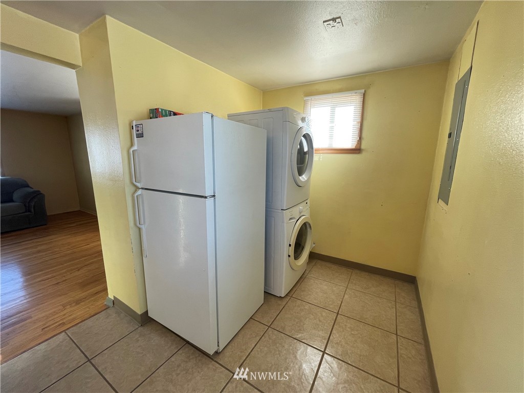 65 F Street Northeast Ephrata, WA 98823 - Photo 12 of 15 a utility room with wooden floor and a refrigerator