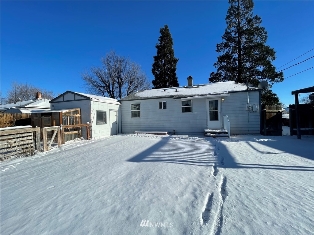 65 F Street Northeast Ephrata, WA 98823 - Photo 14 of 15 a front view of a house with a yard and garage