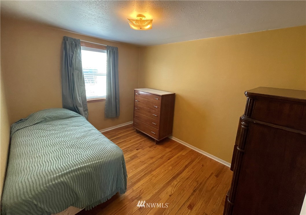 65 F Street Northeast Ephrata, WA 98823 - Photo 8 of 15 a bedroom with a bed and a mirror