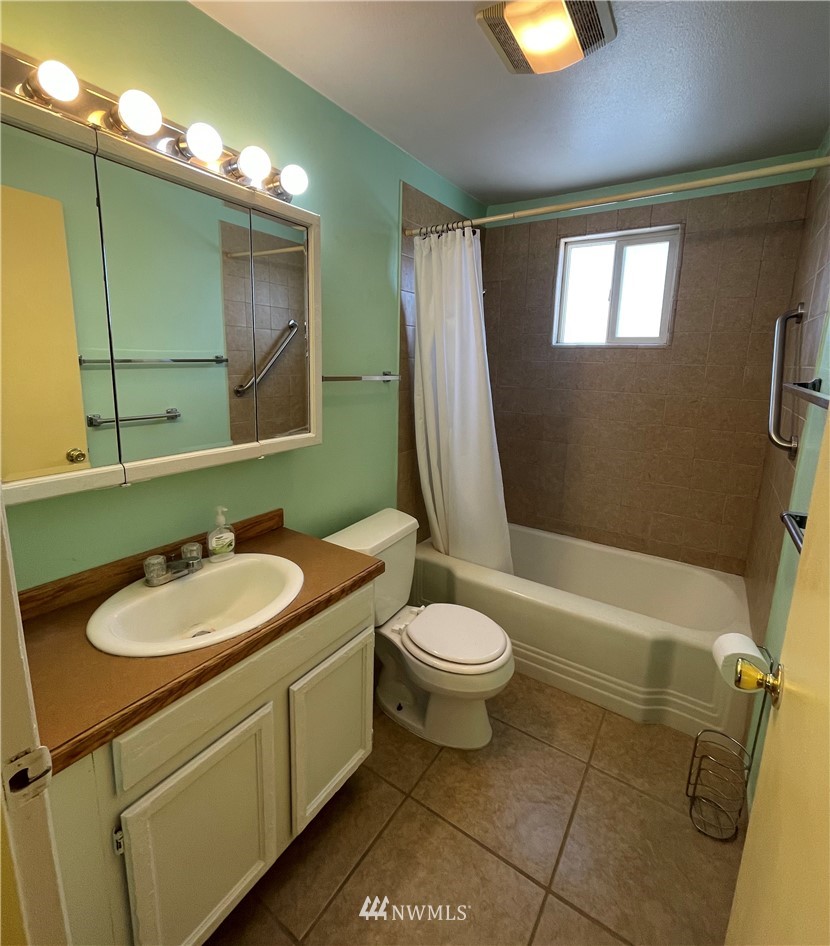 65 F Street Northeast Ephrata, WA 98823 - Photo 9 of 15 a bathroom with a sink a toilet and mirror
