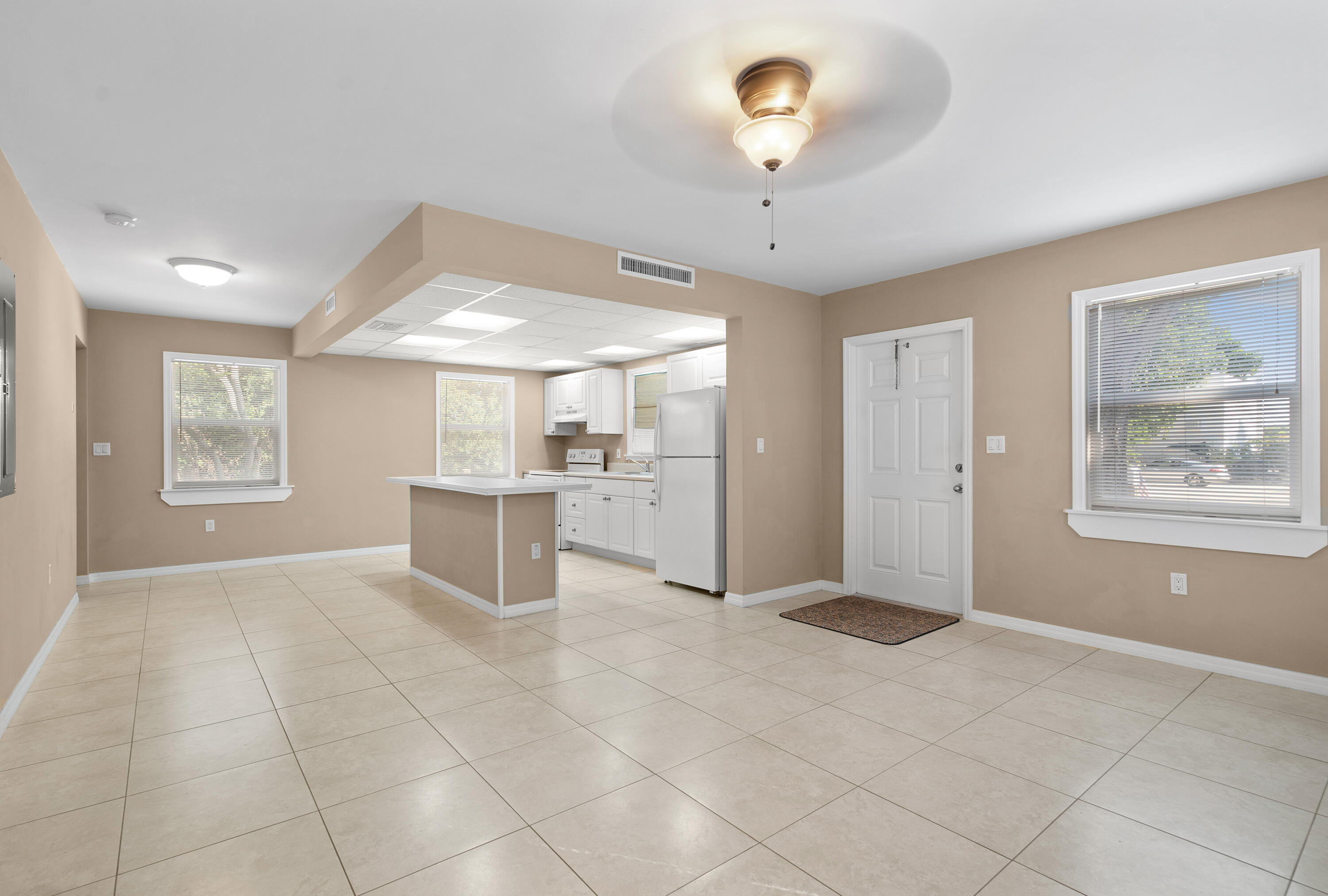 85 Holiday Boulevard Key Largo, FL 33037 - Photo 11 of 20 an empty room with windows and chandelier