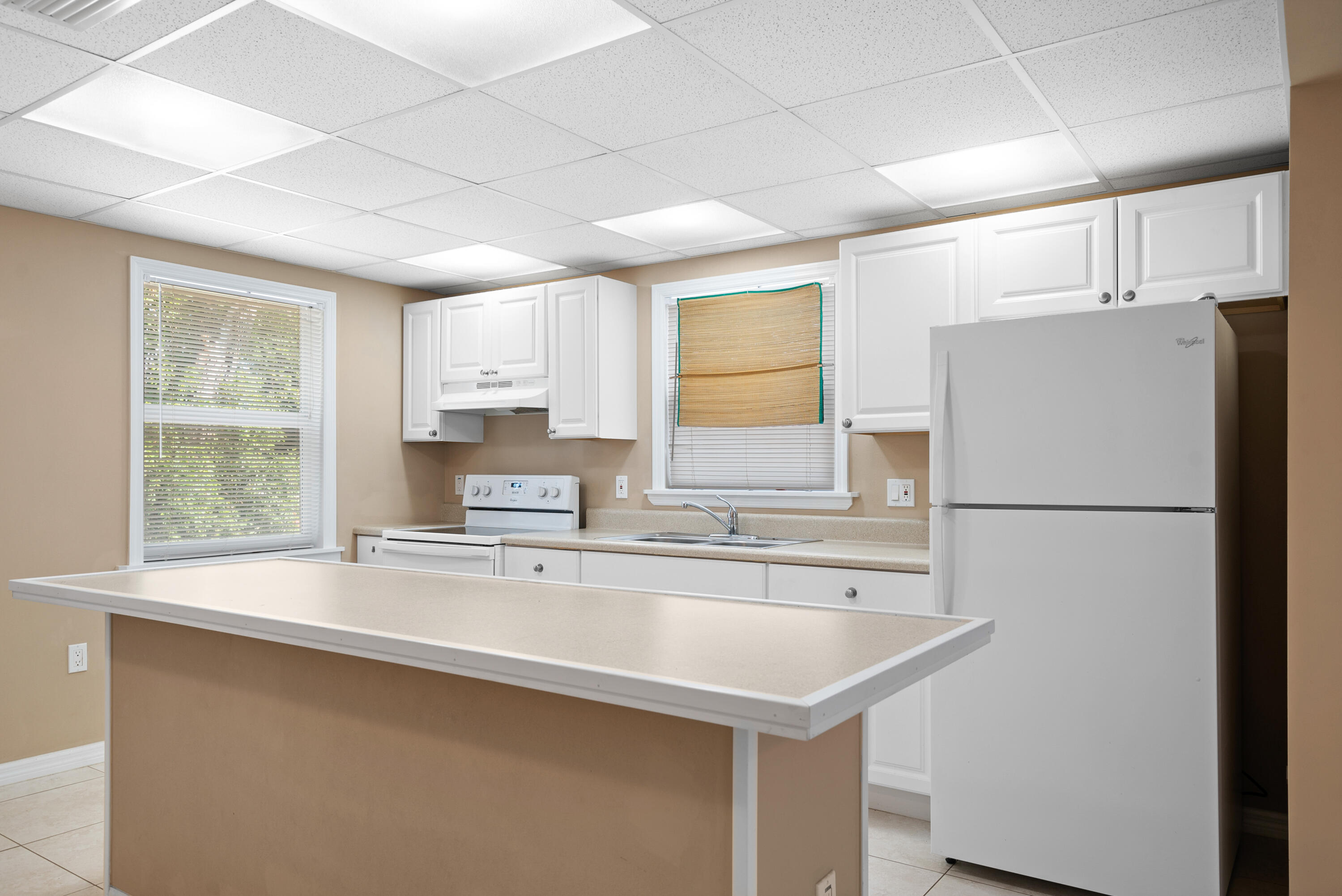 85 Holiday Boulevard Key Largo, FL 33037 - Photo 14 of 20 a white refrigerator freezer sitting inside of a kitchen