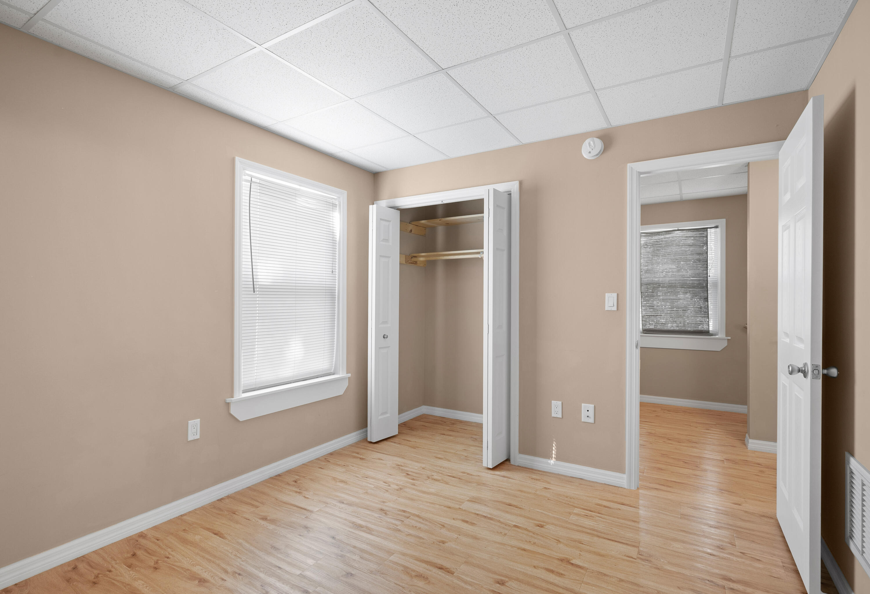 85 Holiday Boulevard Key Largo, FL 33037 - Photo 5 of 20 an empty room with wooden floor and windows