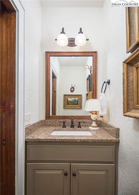 113 Pepperroot Road Boone, NC 28607 - Photo 13 of 50 a bathroom with a granite countertop sink a mirror and