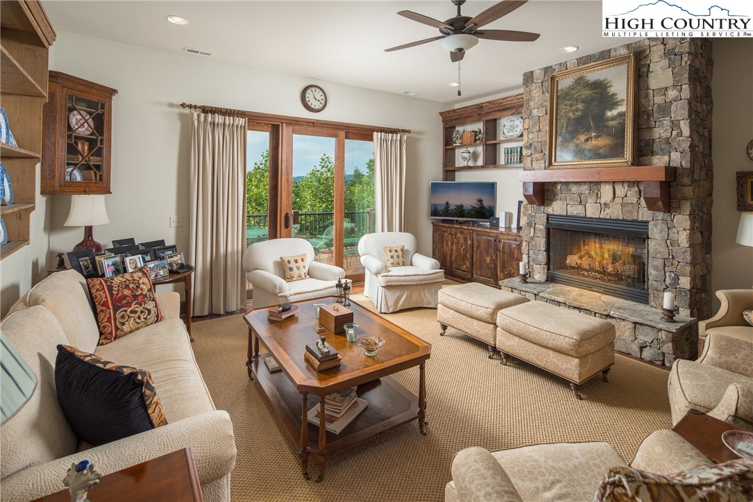 113 Pepperroot Road Boone, NC 28607 - Photo 20 of 50 a living room with furniture fireplace and a large window