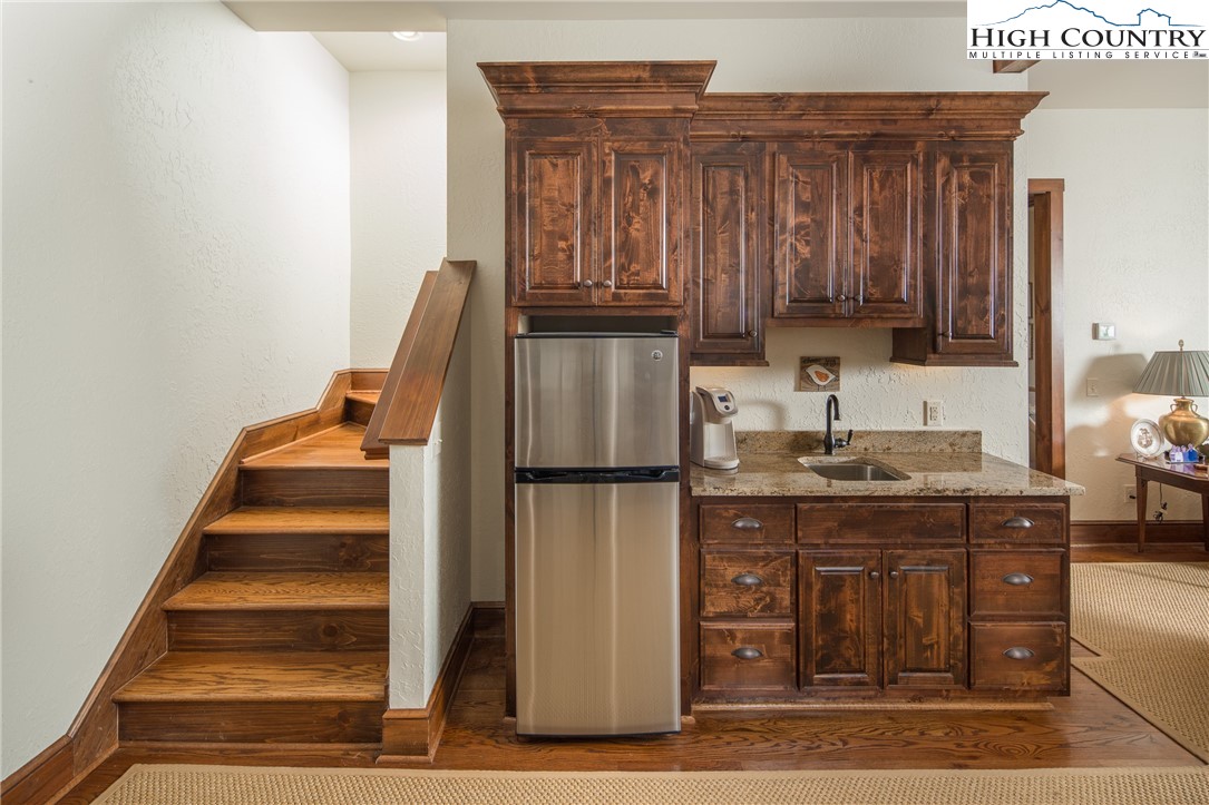 113 Pepperroot Road Boone, NC 28607 - Photo 22 of 50 a kitchen with wooden cabinets and a refrigerator