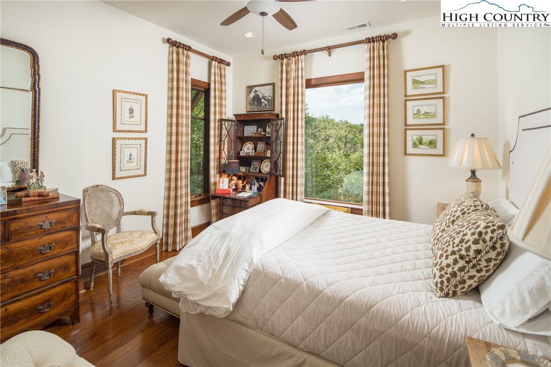 113 Pepperroot Road Boone, NC 28607 - Photo 30 of 50 a bedroom with a bed and wooden floor