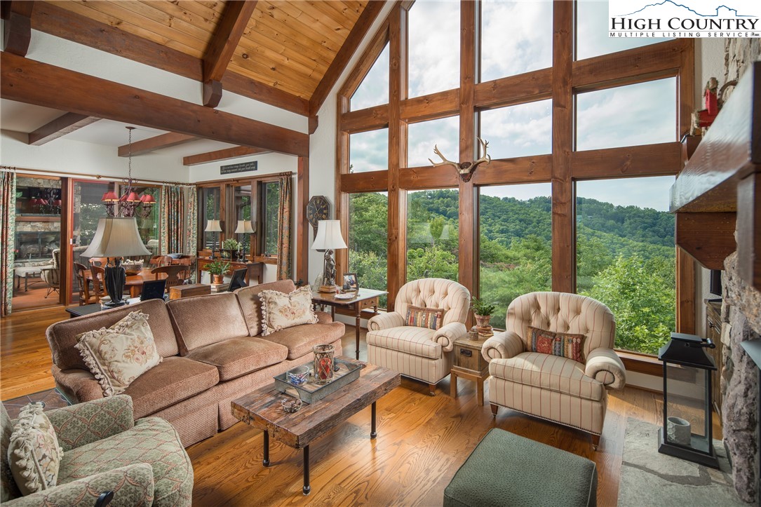 113 Pepperroot Road Boone, NC 28607 - Photo 5 of 50 a living room with furniture and floor to ceiling windows