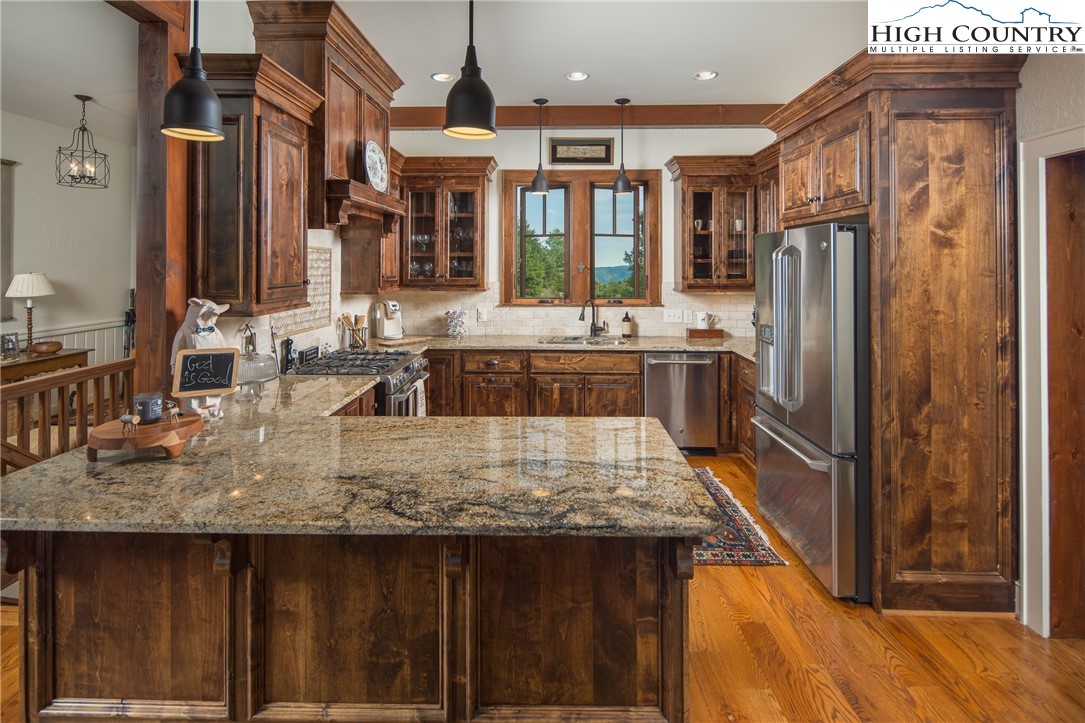 113 Pepperroot Road Boone, NC 28607 - Photo 7 of 50 a kitchen with kitchen island granite countertop a sink and refrigerator