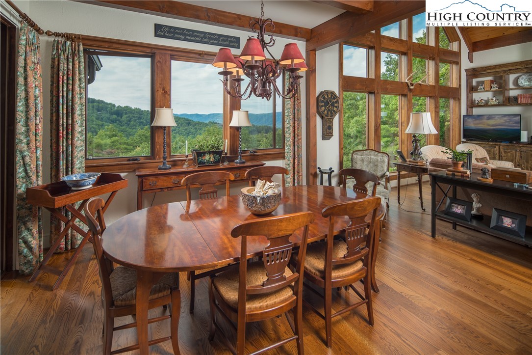 113 Pepperroot Road Boone, NC 28607 - Photo 9 of 50 a dining room with furniture large windows and wooden floor