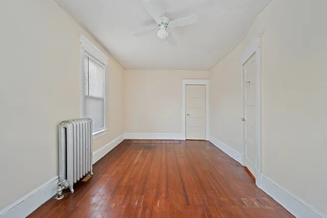 wooden floor in an empty room with a window