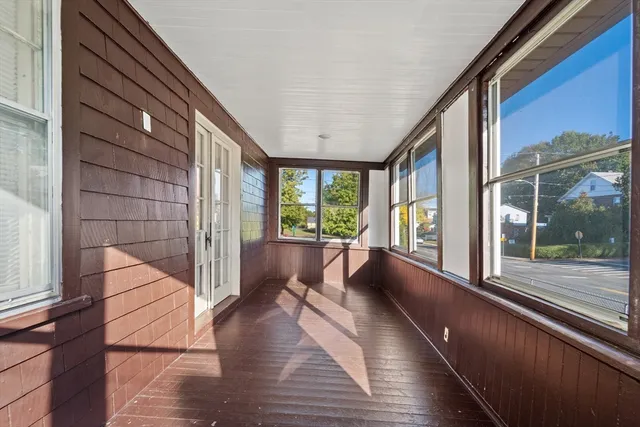a view of an entryway with wooden floor and door